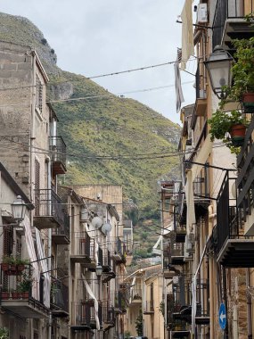 Collesano, a historic Sicilian mountain town in the Madonie Mountains, featuring narrow stone streets, traditional houses, and the Church of San Pietro, Sicily, Italy. Italian town in hills.