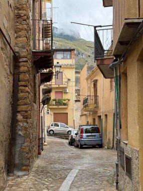 Collesano, a historic Sicilian mountain town in the Madonie Mountains, featuring narrow stone streets, traditional houses, and the Church of San Pietro, Sicily, Italy. Italian town in hills.