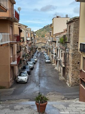 Collesano, a historic Sicilian mountain town in the Madonie Mountains, featuring narrow stone streets, traditional houses, and the Church of San Pietro, Sicily, Italy. Italian town in hills.