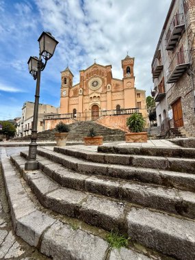 Collesano, a historic Sicilian mountain town in the Madonie Mountains, featuring narrow stone streets, traditional houses, and the Church of San Pietro, Sicily, Italy. Italian town in hills.