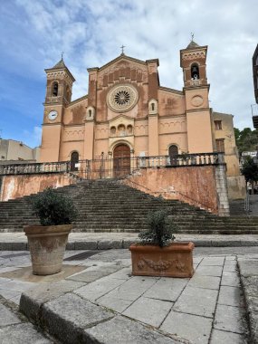 Collesano, a historic Sicilian mountain town in the Madonie Mountains, featuring narrow stone streets, traditional houses, and the Church of San Pietro, Sicily, Italy. Italian town in hills.