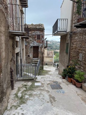 Collesano, a historic Sicilian mountain town in the Madonie Mountains, featuring narrow stone streets, traditional houses, and the Church of San Pietro, Sicily, Italy. Italian town in hills.