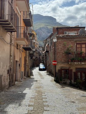 Collesano, a historic Sicilian mountain town in the Madonie Mountains, featuring narrow stone streets, traditional houses, and the Church of San Pietro, Sicily, Italy. Italian town in hills.