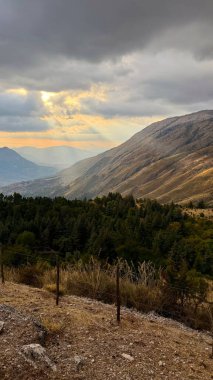 Mountainous central Sicilian landscape near Campofelice di Roccella, Italy, featuring rolling hills, distant Tyrrhenian Sea views, and the volcanic Islands on the horizon under.