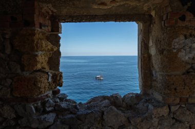 Capo Zafferano Italian coastal promontory and lighthouse by the Tyrrhenian Sea in Bagheria, Sicily Italy with rugged cliffs lush Mediterranean flora crystal clear water.