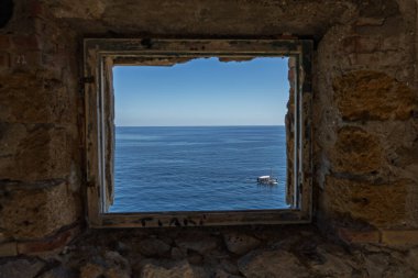 Capo Zafferano Italian coastal promontory and lighthouse by the Tyrrhenian Sea in Bagheria, Sicily Italy with rugged cliffs lush Mediterranean flora crystal clear water.