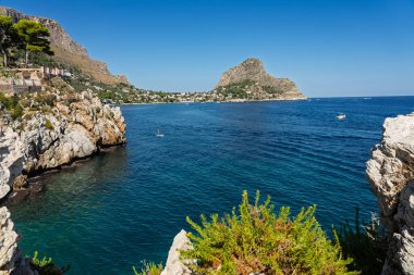 Capo Zafferano Italian coastal promontory and lighthouse by the Tyrrhenian Sea in Bagheria, Sicily Italy with rugged cliffs lush Mediterranean flora crystal clear water.