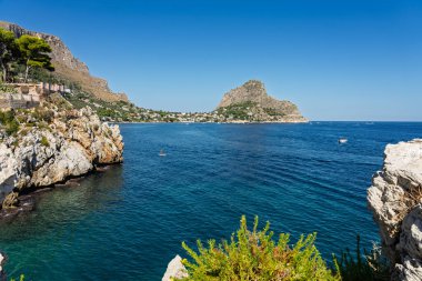 Capo Zafferano Italian coastal promontory and lighthouse by the Tyrrhenian Sea in Bagheria, Sicily Italy with rugged cliffs lush Mediterranean flora crystal clear water.