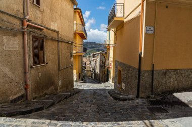 Caltavuturo, a historic Sicilian mountain town in the Madonie Mountains, featuring its medieval castle, charming narrow streets, and traditional stone houses, Sicily, Italy. Italian town in hills.