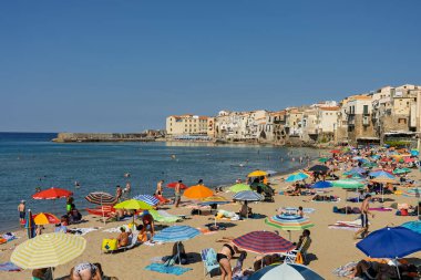 Cefalu, a historic Sicilian coastal town in northern Sicily, Italy, charming narrow streets, the Cathedral Basilica of the Transfiguration of the Lord, golden beach, and view of the Tyrrhenian Sea.