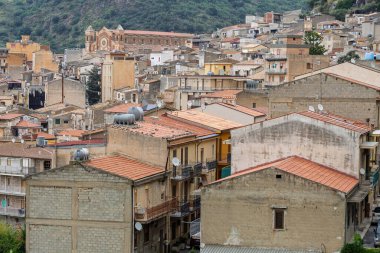 Collesano, a historic Sicilian mountain town in the Madonie Mountains, featuring narrow stone streets, traditional houses, and the Church of San Pietro, Sicily, Italy. Italian town in hills.