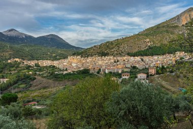 Collesano, a historic Sicilian mountain town in the Madonie Mountains, featuring narrow stone streets, traditional houses, and the Church of San Pietro, Sicily, Italy. Italian town in hills.