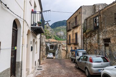 Collesano, a historic Sicilian mountain town in the Madonie Mountains, featuring narrow stone streets, traditional houses, and the Church of San Pietro, Sicily, Italy. Italian town in hills.