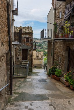 Collesano, a historic Sicilian mountain town in the Madonie Mountains, featuring narrow stone streets, traditional houses, and the Church of San Pietro, Sicily, Italy. Italian town in hills.
