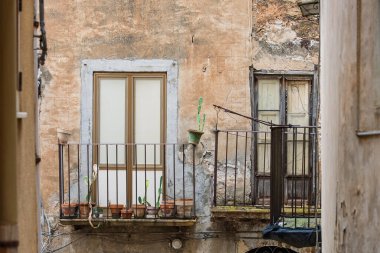 Collesano, a historic Sicilian mountain town in the Madonie Mountains, featuring narrow stone streets, traditional houses, and the Church of San Pietro, Sicily, Italy. Italian town in hills.