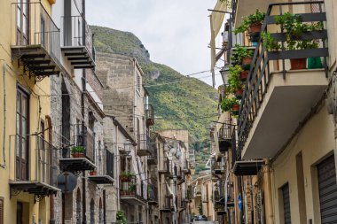 Collesano, a historic Sicilian mountain town in the Madonie Mountains, featuring narrow stone streets, traditional houses, and the Church of San Pietro, Sicily, Italy. Italian town in hills.