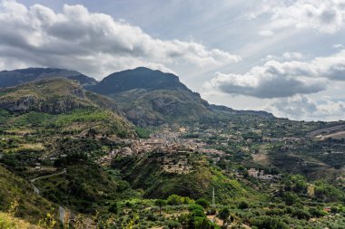 Collesano, a historic Sicilian mountain town in the Madonie Mountains, featuring narrow stone streets, traditional houses, and the Church of San Pietro, Sicily, Italy. Italian town in hills.