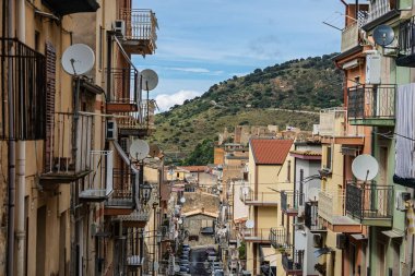 Collesano, a historic Sicilian mountain town in the Madonie Mountains, featuring narrow stone streets, traditional houses, and the Church of San Pietro, Sicily, Italy. Italian town in hills.