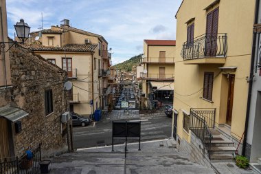Collesano, a historic Sicilian mountain town in the Madonie Mountains, featuring narrow stone streets, traditional houses, and the Church of San Pietro, Sicily, Italy. Italian town in hills.