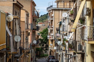 Collesano, a historic Sicilian mountain town in the Madonie Mountains, featuring narrow stone streets, traditional houses, and the Church of San Pietro, Sicily, Italy. Italian town in hills.