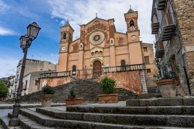 Collesano, a historic Sicilian mountain town in the Madonie Mountains, featuring narrow stone streets, traditional houses, and the Church of San Pietro, Sicily, Italy. Italian town in hills.