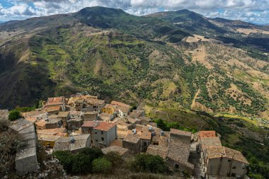 Sclafani Bagni, a small historic Sicilian mountain village perched on cliffs, featuring traditional stone houses, narrow streets, and panoramic views of the rugged Madonie Mountains, Sicily, Italy.