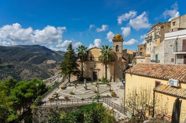 Sclafani Bagni, a small historic Sicilian mountain village perched on cliffs, featuring traditional stone houses, narrow streets, and panoramic views of the rugged Madonie Mountains, Sicily, Italy.