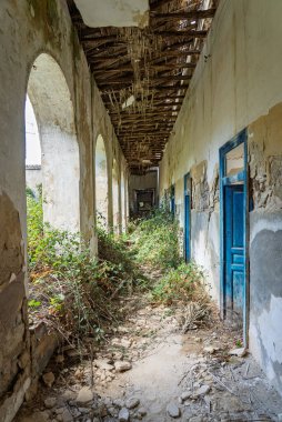 Abandoned sanatorium with a historic church in Sclafani Bagni, a small Sicilian mountain village in the Madonie Mountains, featuring decayed stone buildings and scenic landscapes, Sicily, Italy.