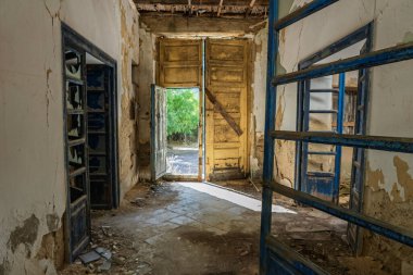 Abandoned sanatorium with a historic church in Sclafani Bagni, a small Sicilian mountain village in the Madonie Mountains, featuring decayed stone buildings and scenic landscapes, Sicily, Italy.