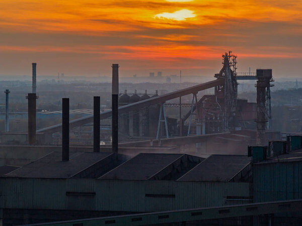 Aerial drone view of Industrial steel factory, iron works. Metallurgical plant. steelworks. Heavy industry in Europe, Poland, Dabrowa Gornicza. Air pollution from chimneys. Ecology and environmental.