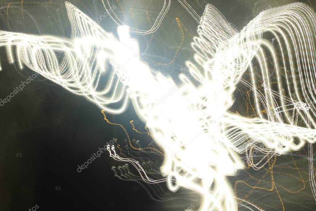 Light painting in white hues. It looks like a flying bird.