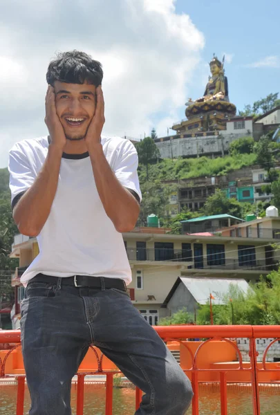 Young Guy Posing Funny Sitting Safety Barrier Lake Beautiful Hilly — Stock Photo, Image