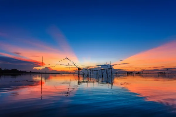 Throwing fishing net during sunrise, Thailand — Stock Photo © Kanoke46  #119026796