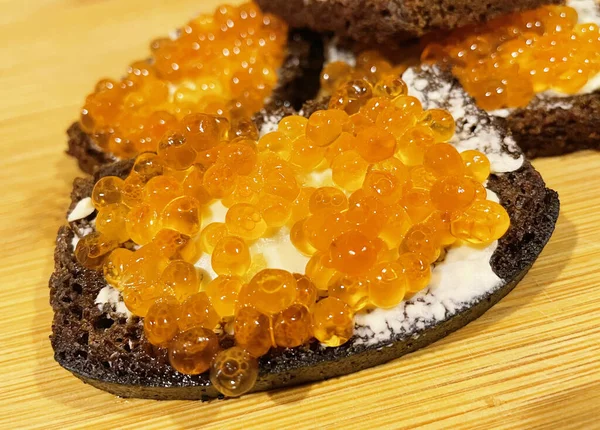 Rode kaviaar op zwart brood met boter — Stockfoto