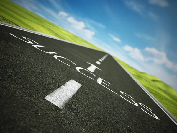 Asphalt road with arrow and success text against blue sky — Stock Photo, Image