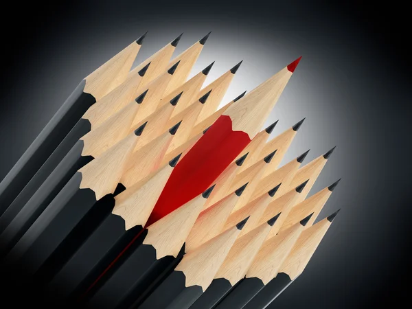 Červenou tužkou, stojící mezi černé tužky — Stock fotografie