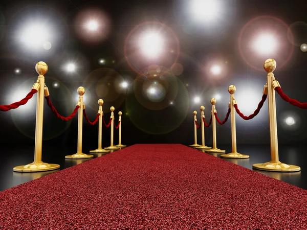 Red carpet at night with flashlights — Stock Photo, Image