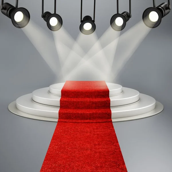 Alfombra roja que conduce al escenario iluminada por focos — Foto de Stock