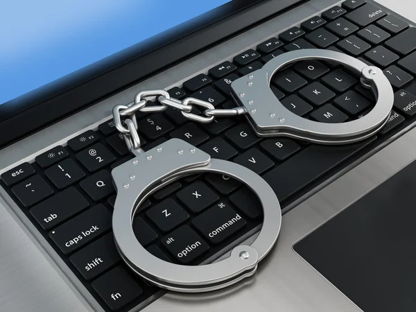 Handcuffs standing on laptop computer — Stock Photo, Image