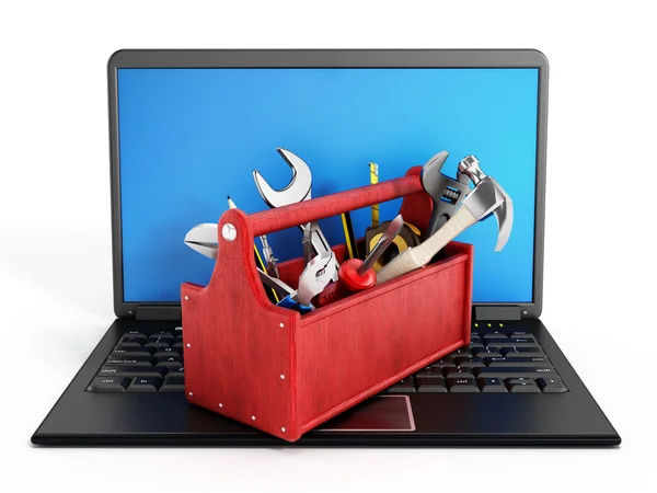 Boîte à outils rouge debout sur ordinateur portable — Photo