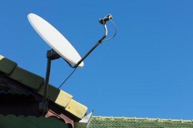 Evin çatısında uydu anteni ve televizyon anteni var.