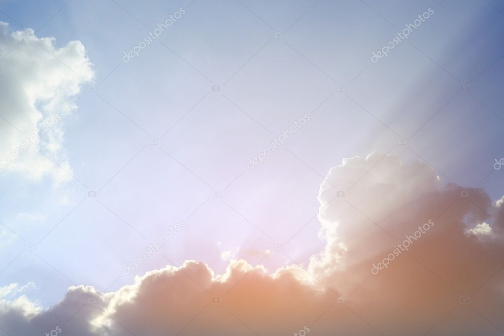 light rays of sun on clear blue sky background