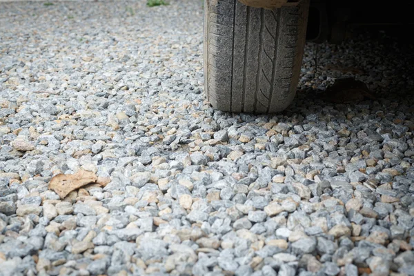 Car wheel vehicle on gravel construction road — Stock Photo, Image