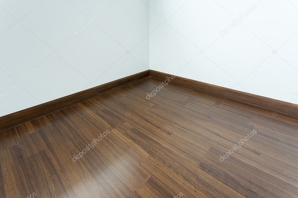 empty room interior, brown wood laminate floor and white mortar 