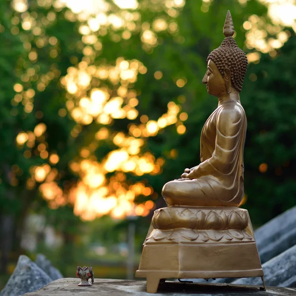 Estátua buda dourada escultura com fundo de luz bokeh — Fotografia de Stock