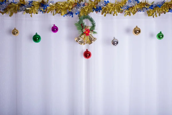 Christmas background, bell decorate on white curtain — Stock Photo, Image