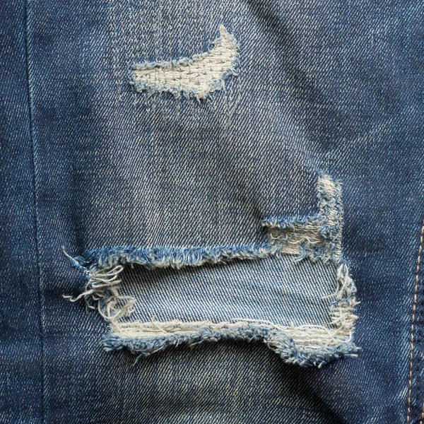 粗斜纹棉布牛仔裤蓝色又旧又破的时尚设计 — 图库照片