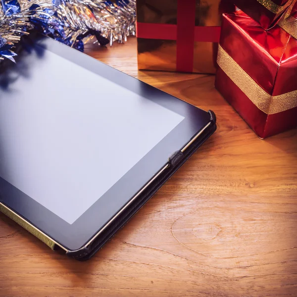 Black tablet on table wood with christmas decoration — Stock Photo, Image