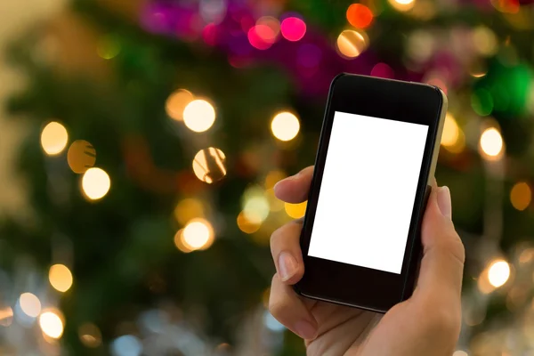 Renkli ışık kutlama ile mobil akıllı telefon kullanarak ele — Stok fotoğraf