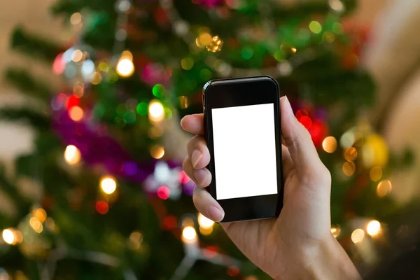 Renkli ışık kutlama ile mobil akıllı telefon kullanarak ele — Stok fotoğraf